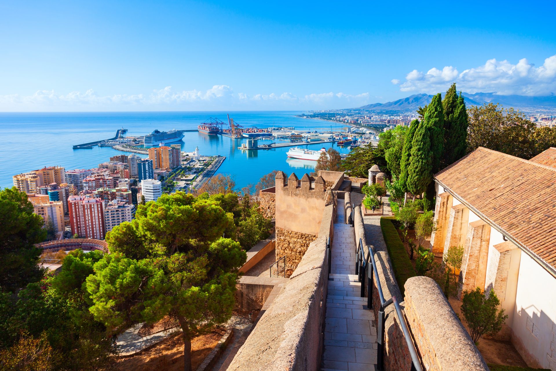 Alt text: Panoramic city view from a cozy balcony with a private staircase.