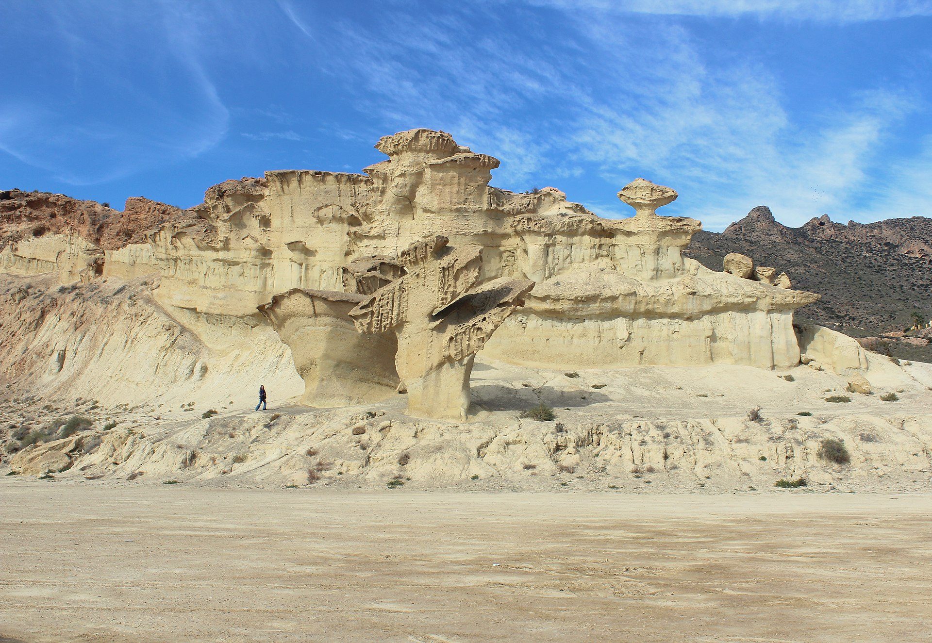Desert landscape with unique rock formations and a clear blue sky.