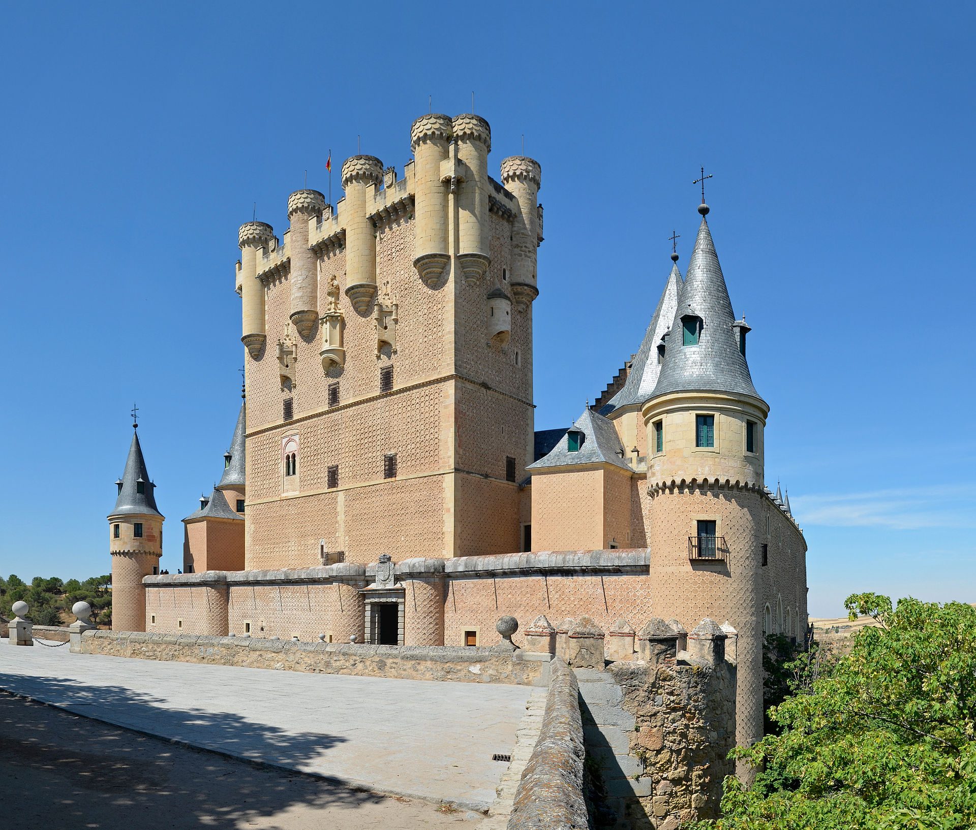 A medieval castle with multiple towers and a panoramic view of the surrounding landscape.