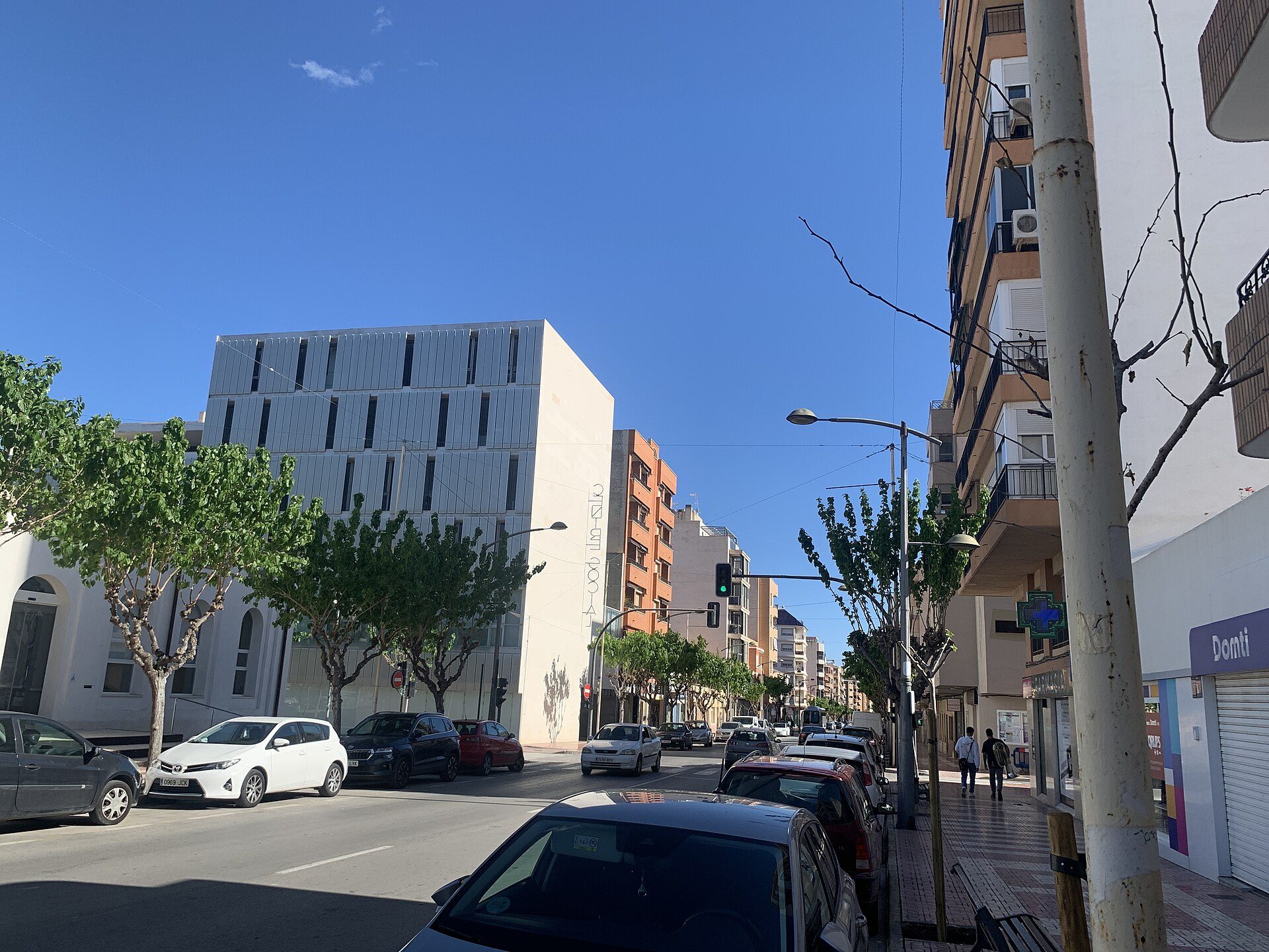 Modern apartment with city view, balcony, and large windows.