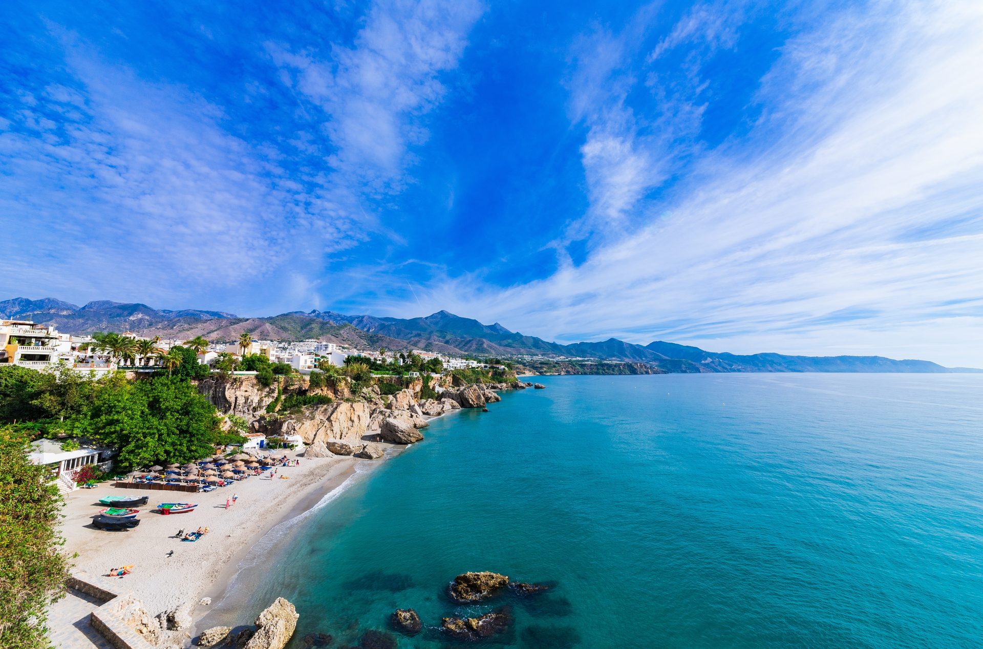 Oceanfront room with stunning sea and mountain view, featuring a private balcony.