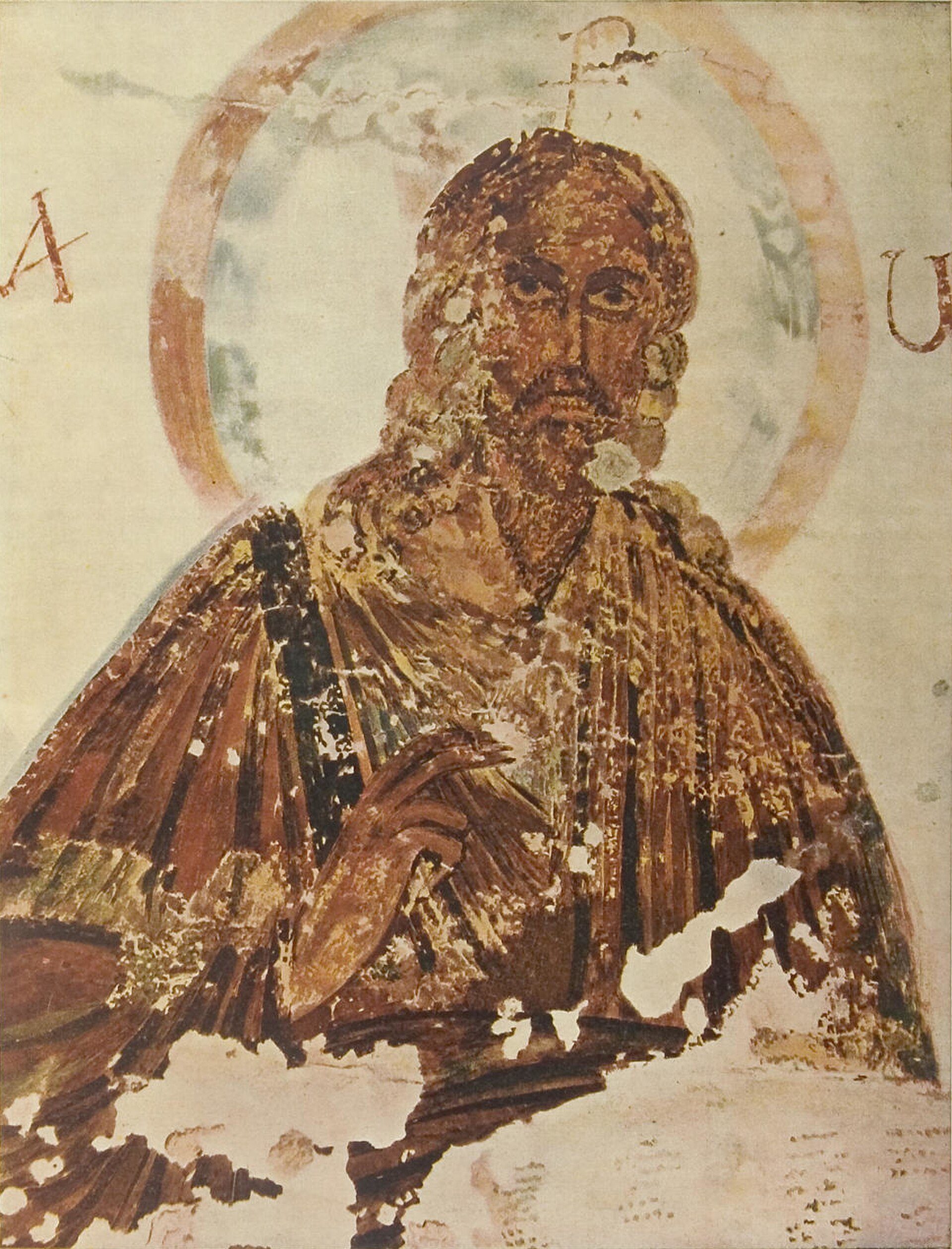 Alt text: Ancient fresco of a bearded saint holding a book, with a halo and ornate robe.