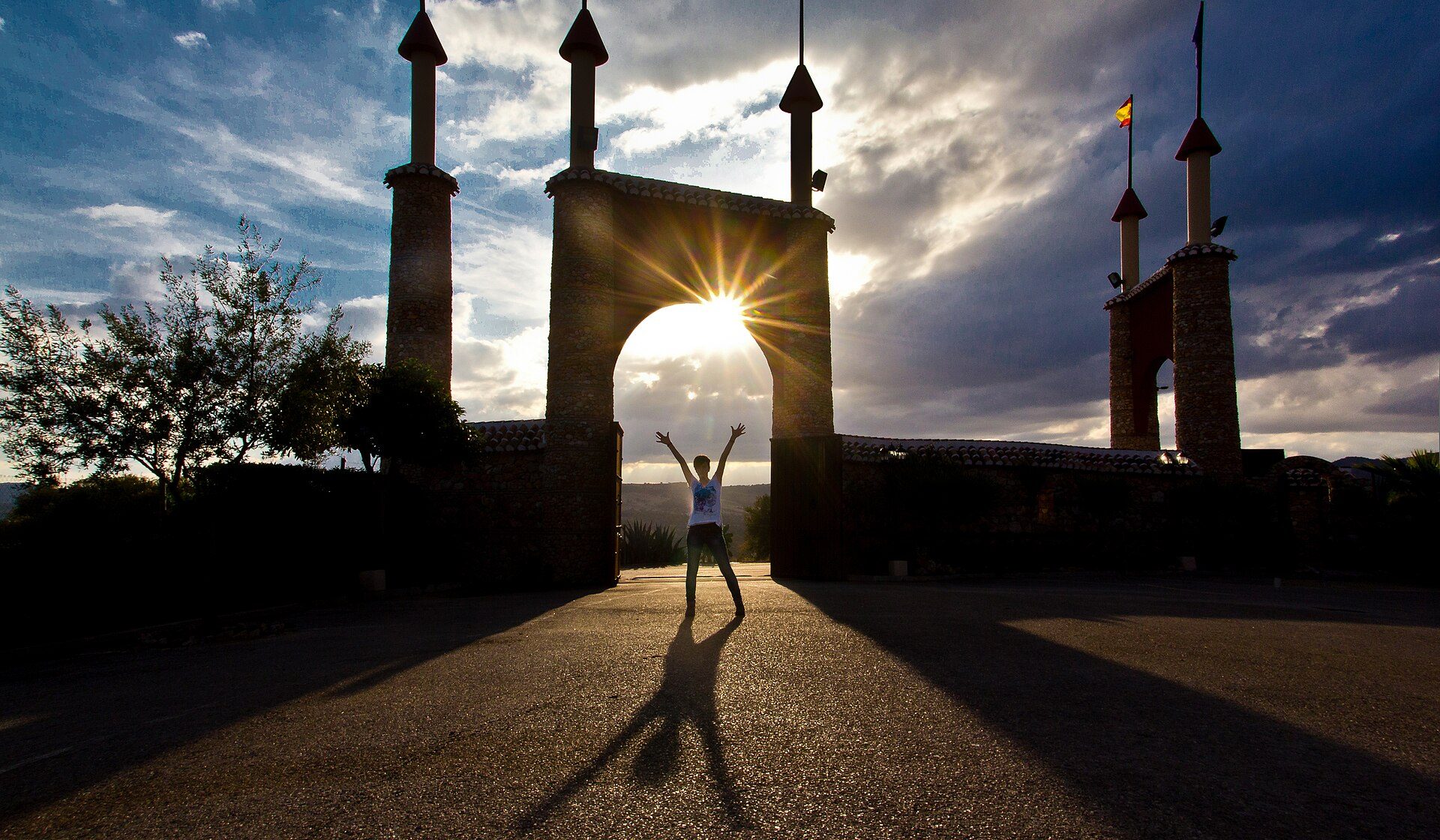 Sunset view from a spacious room with a balcony and modern decor.