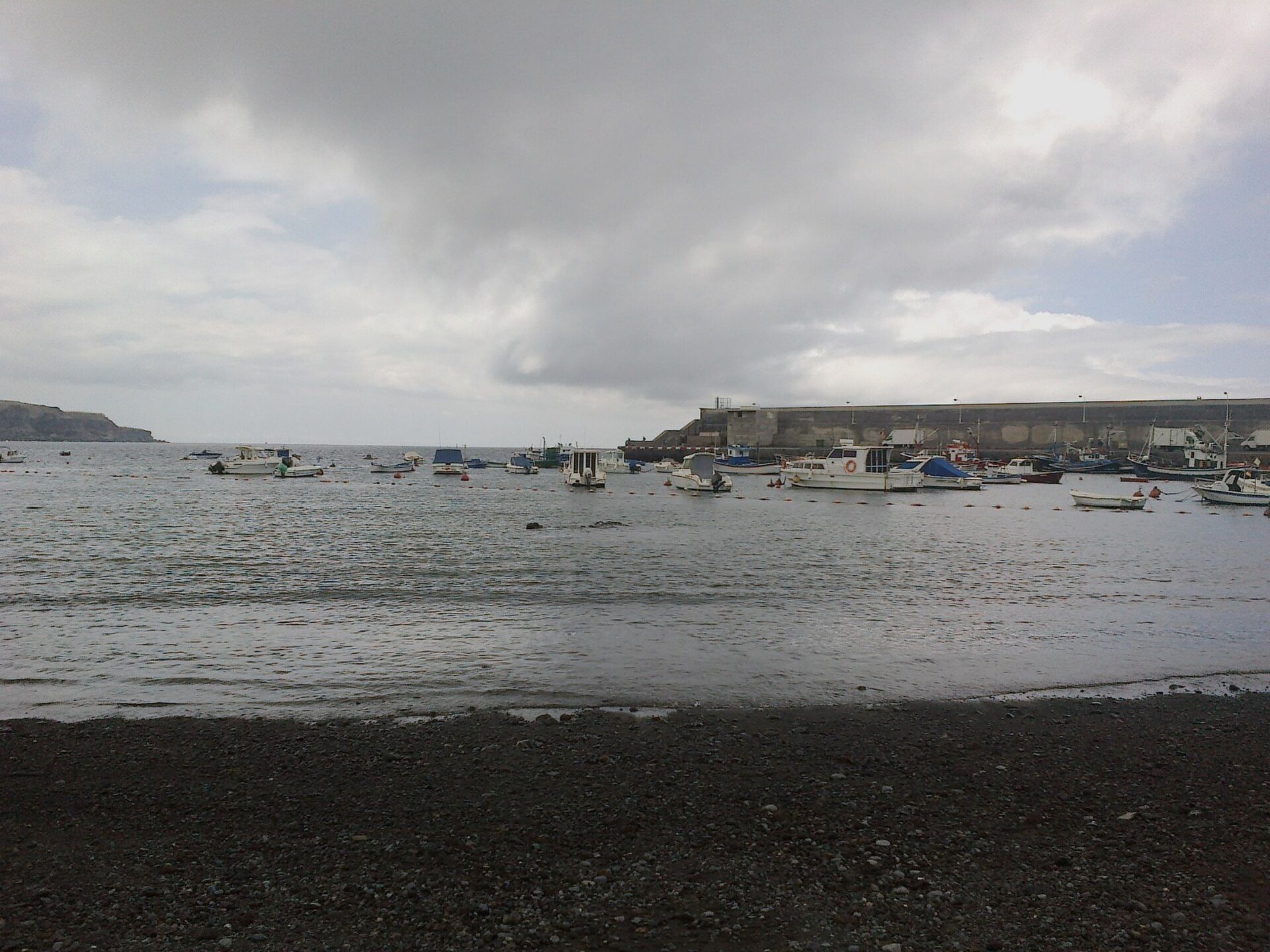Cozy room with harbor view, featuring large windows and comfortable seating.