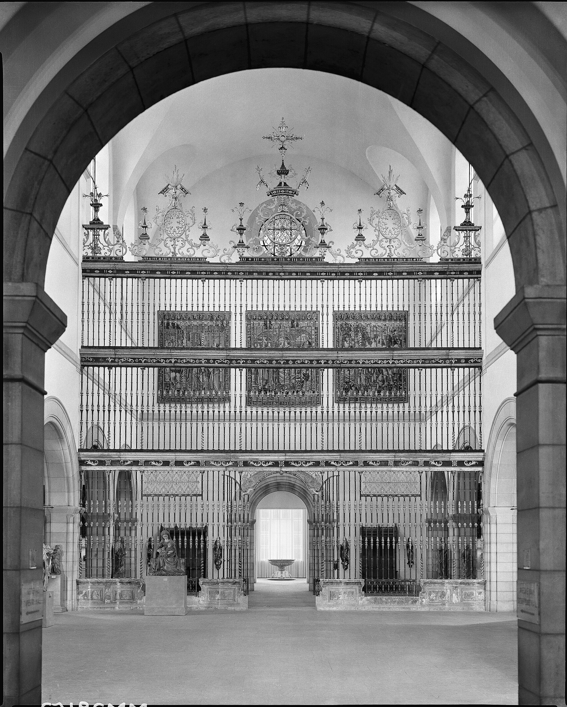 Black and white photo of a grand, ornate chapel interior with arched windows and decorative chandeliers.