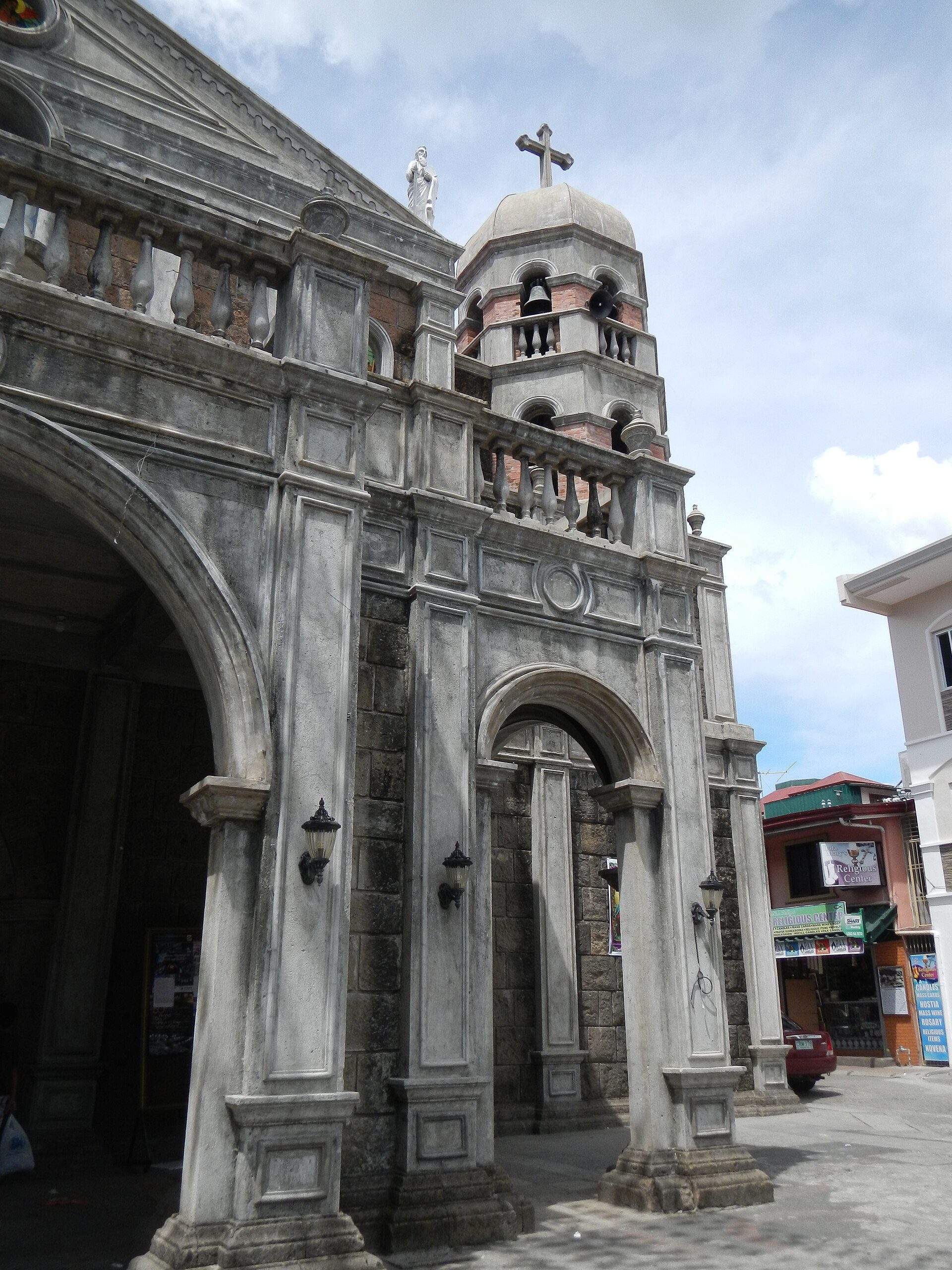 Alt text: Historic stone church with arched entrance and bell tower.