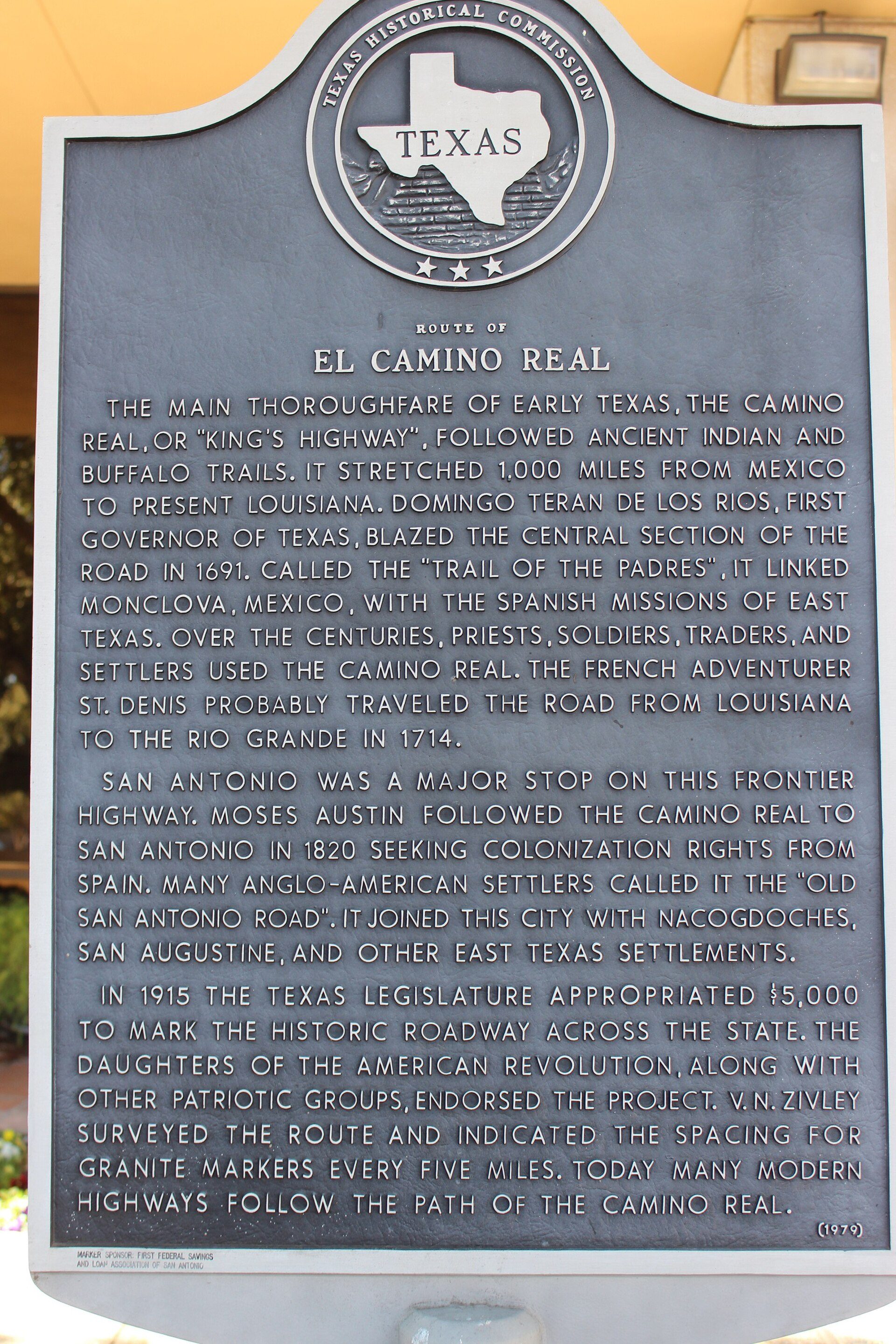 Historical marker detailing the Camino Real in Texas, with a circular emblem and text.
