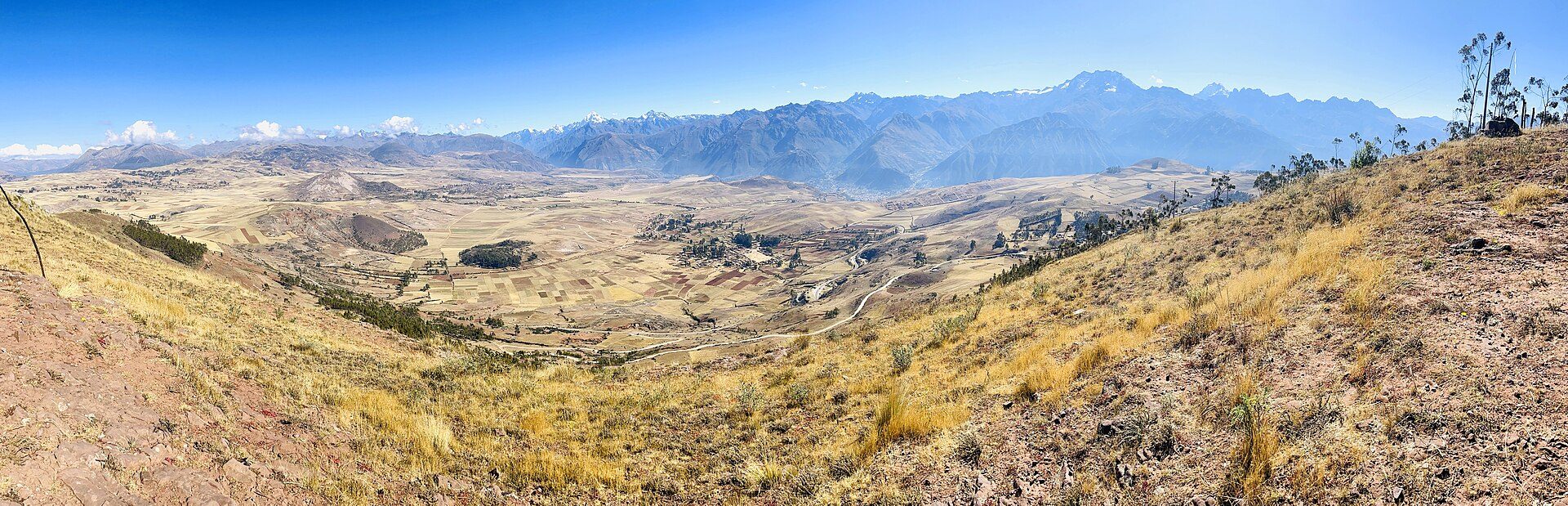 Alt text: Panoramic mountain view from a cozy room with large windows and comfortable seating.