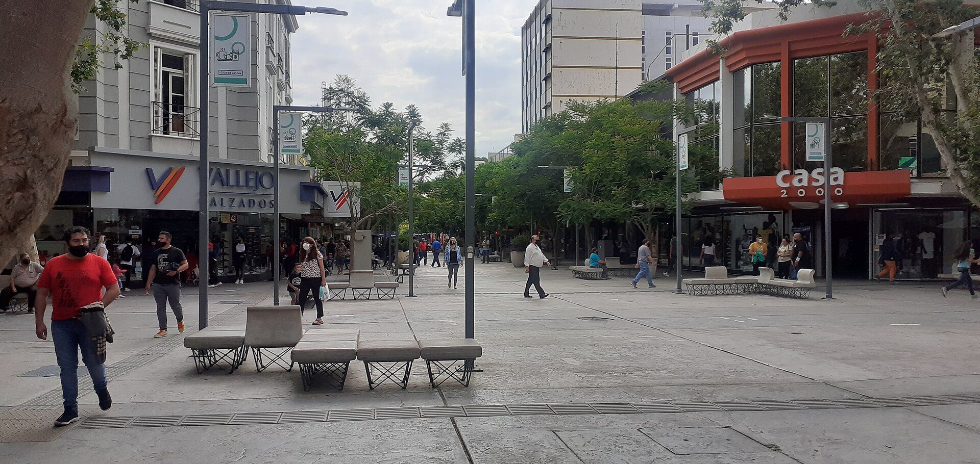 Alt text: Modern room with city view, featuring large windows and comfortable seating.