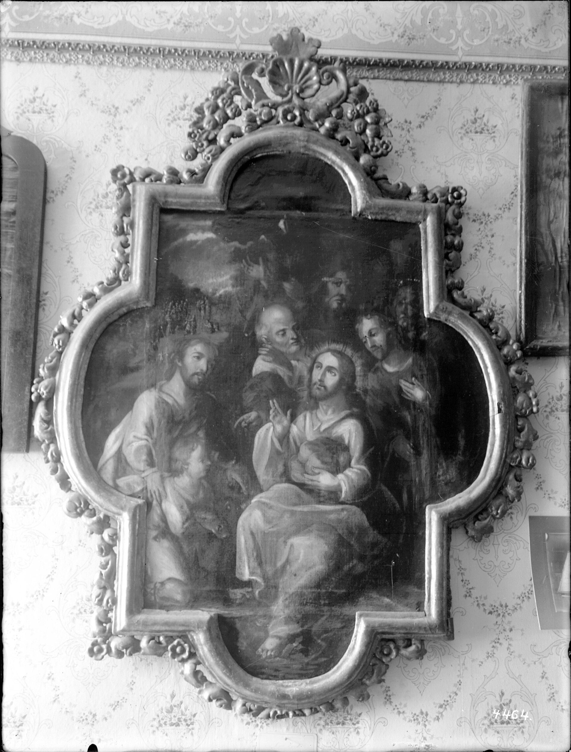 A framed religious painting of Jesus and figures, displayed on a patterned wall.