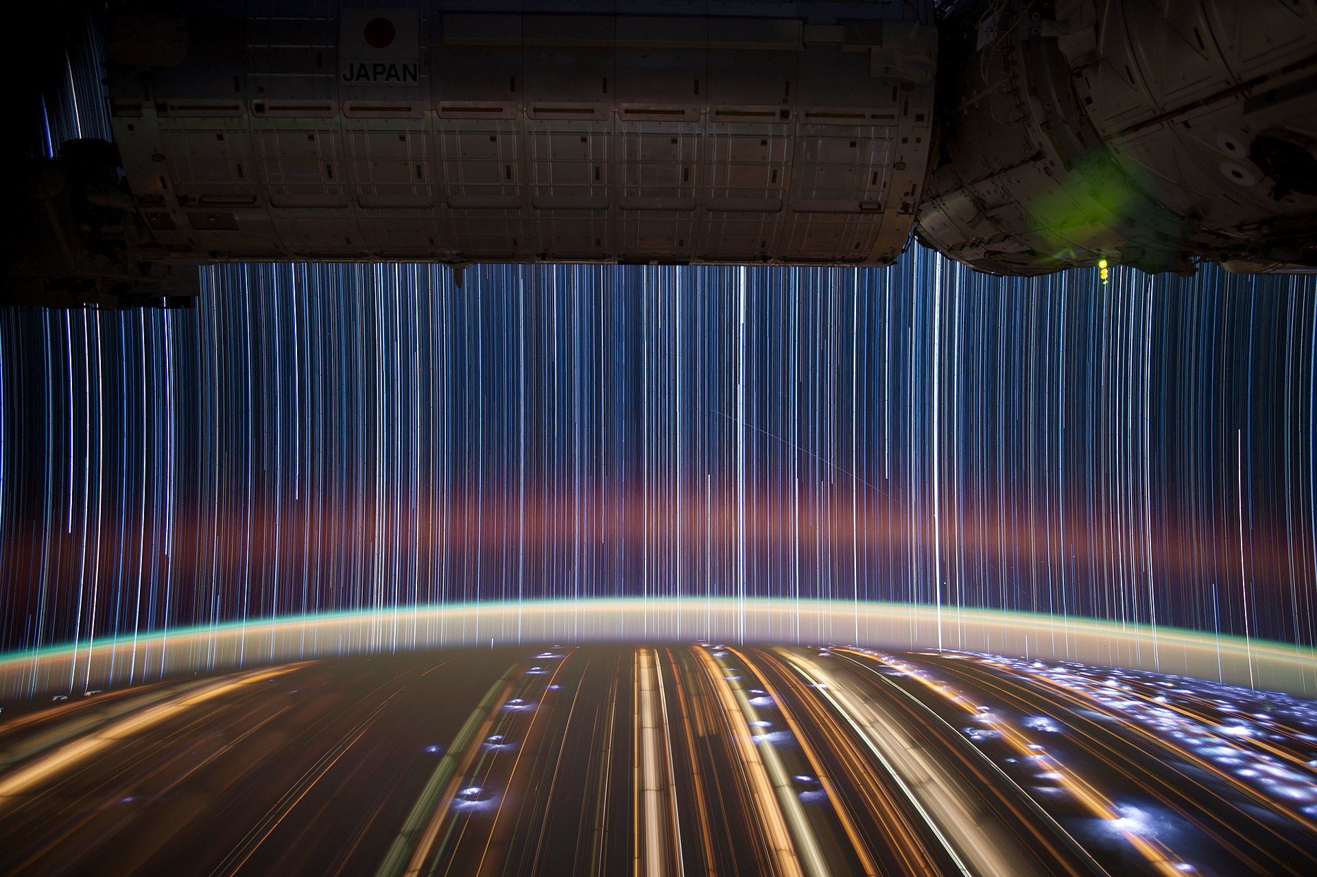 Astronaut's perspective: spacious room with panoramic view of Earth and star trails.