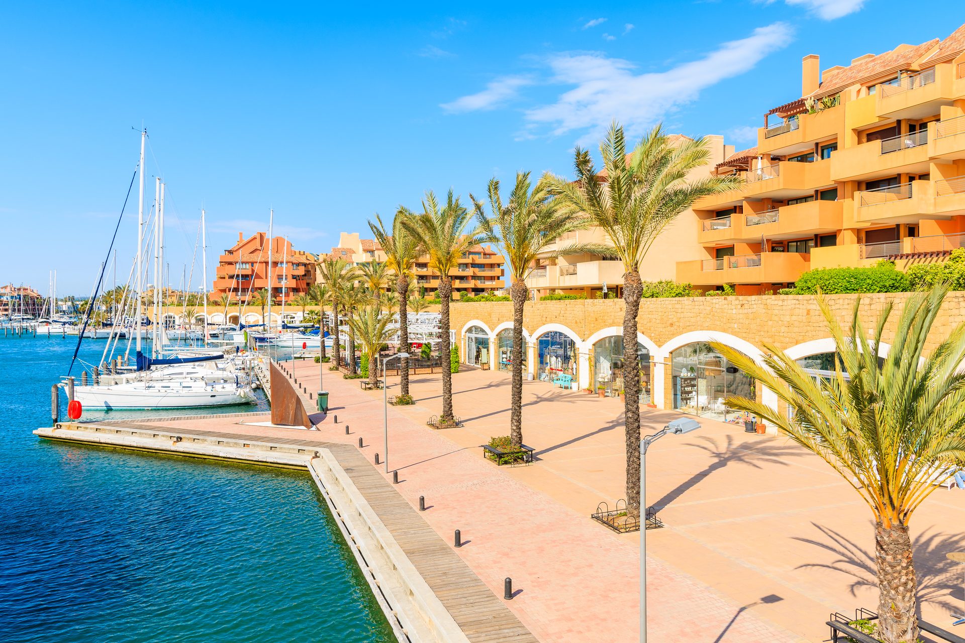 A luxurious waterfront apartment with a marina view, featuring a spacious balcony and modern amenities.