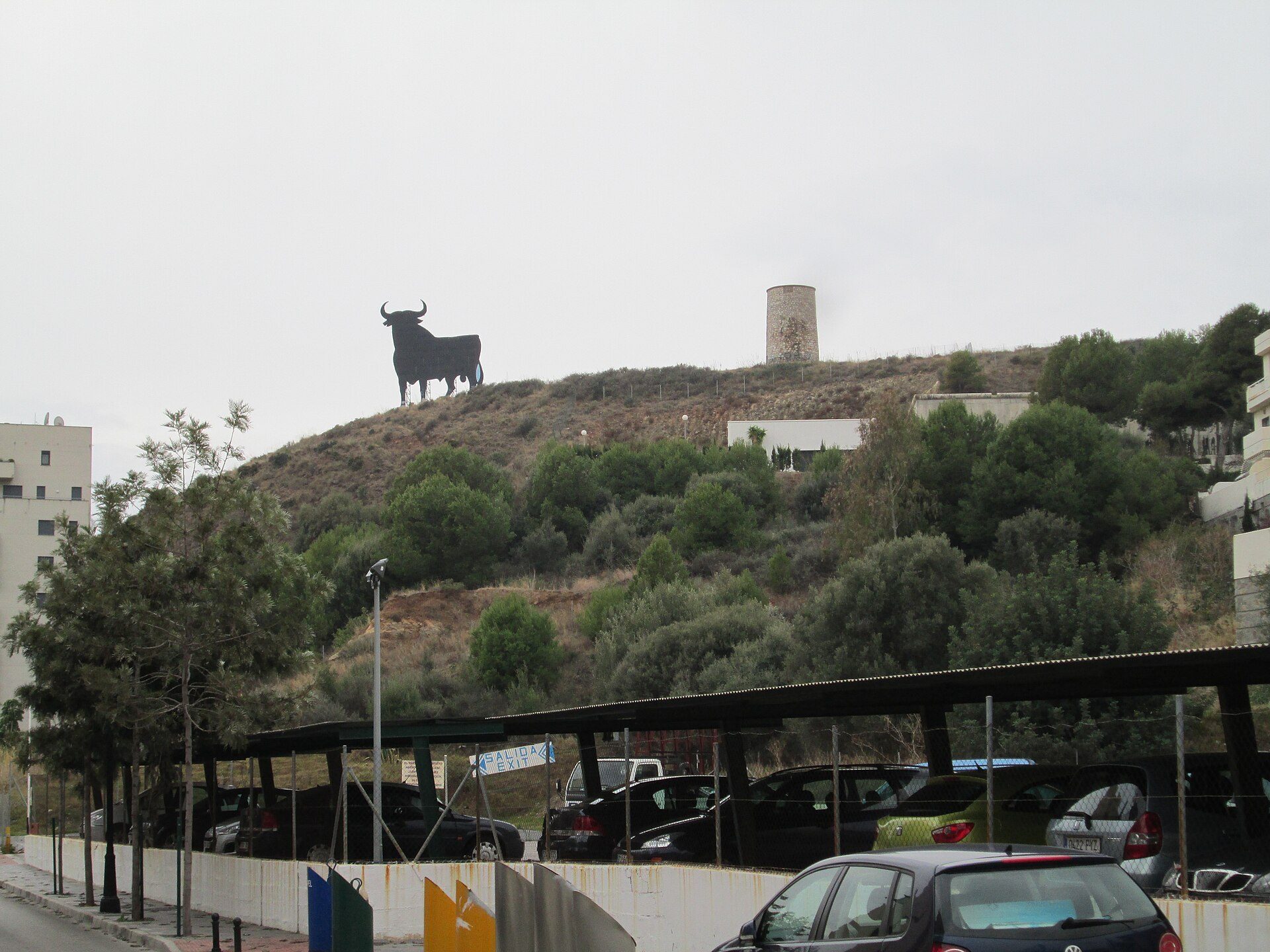 Alt text: "Mountain view room with balcony, featuring a large bull statue and a tower.