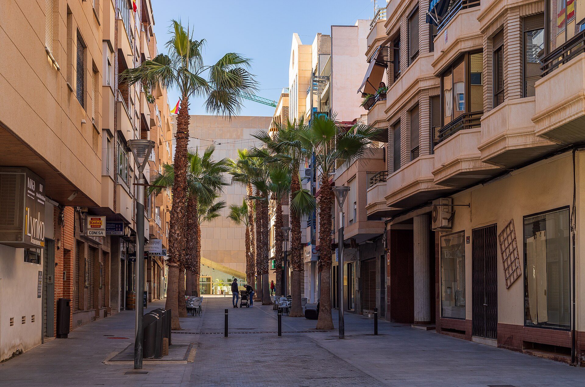 Alt text: Spacious apartment with city view, modern kitchen, and balcony.