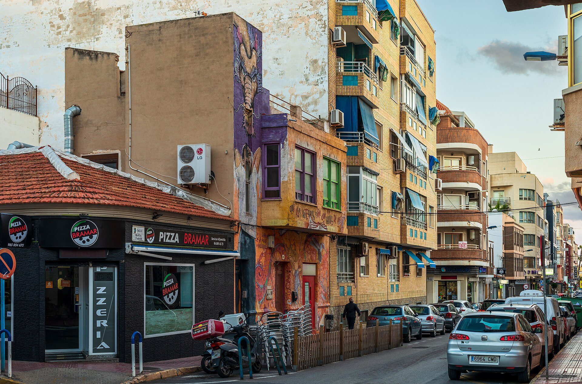 Alt text: Studio apartment with city view, featuring a balcony and modern decor.