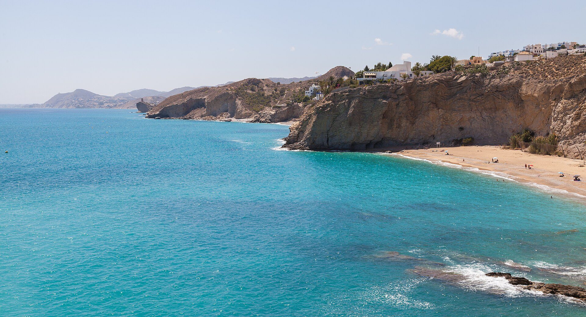 Oceanfront room with stunning blue sea and cliffside view, featuring a private balcony.