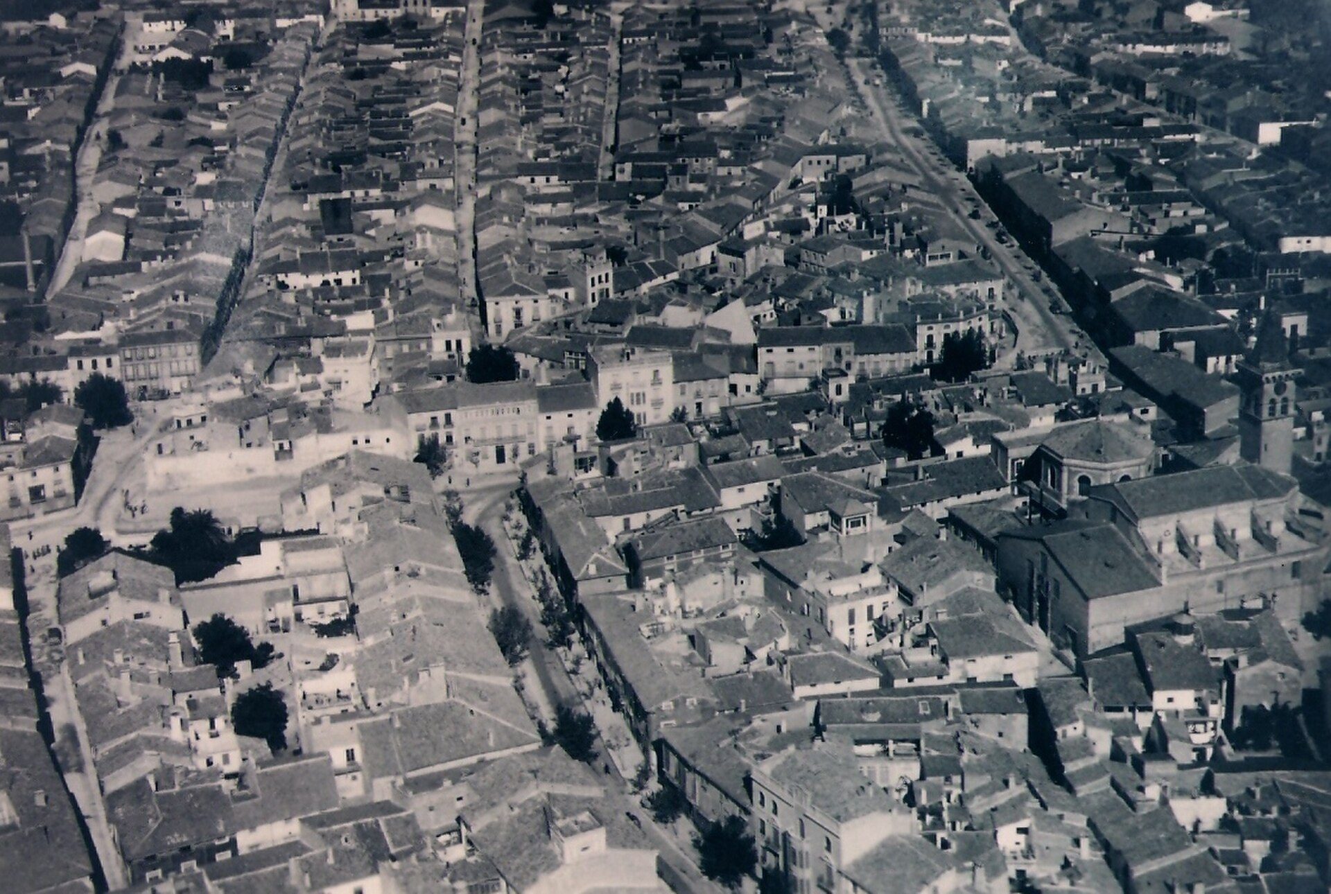 Aerial view of a historic town with narrow streets and dense buildings.