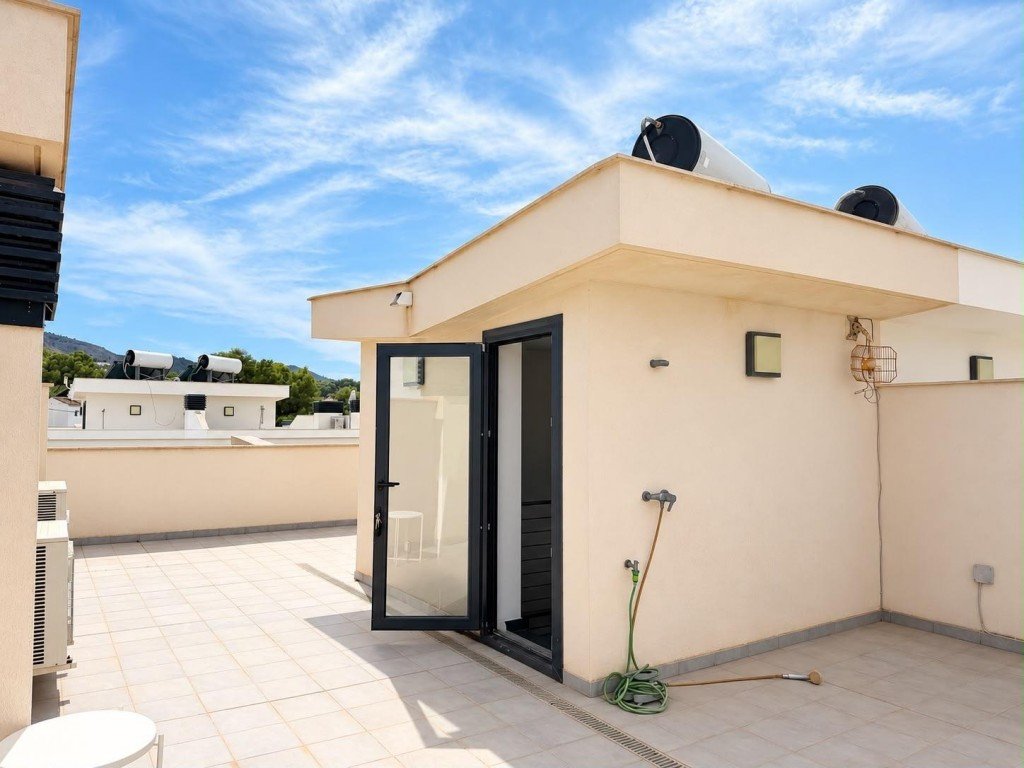 Rooftop terrace with tiled flooring, glass doors, and solar water heaters