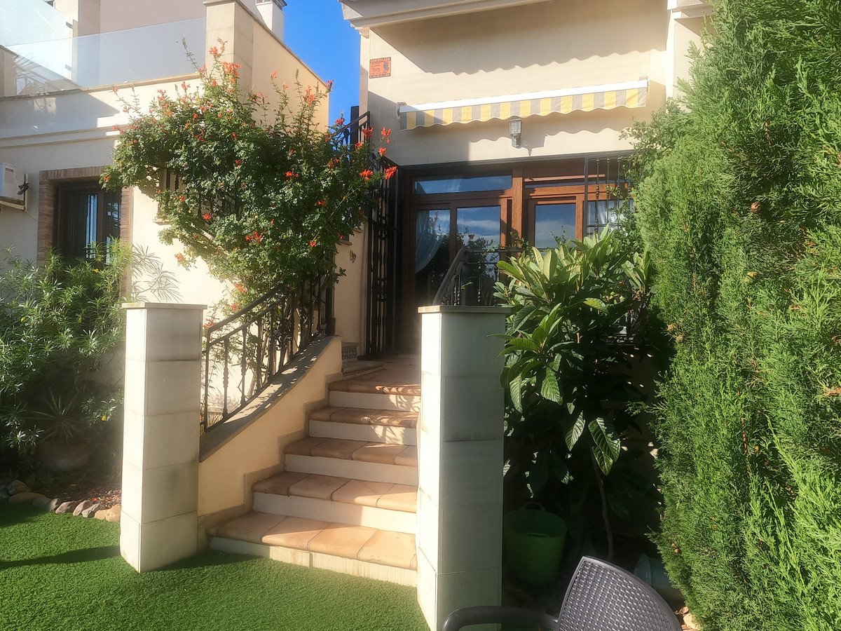 Villa entrance with stairs, garden, and outdoor seating area