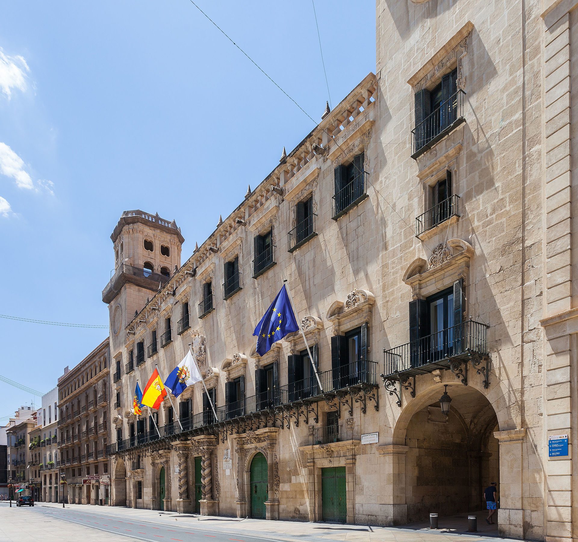 Alt text: Historic building with European Union flag, arched entrance, and balconies.