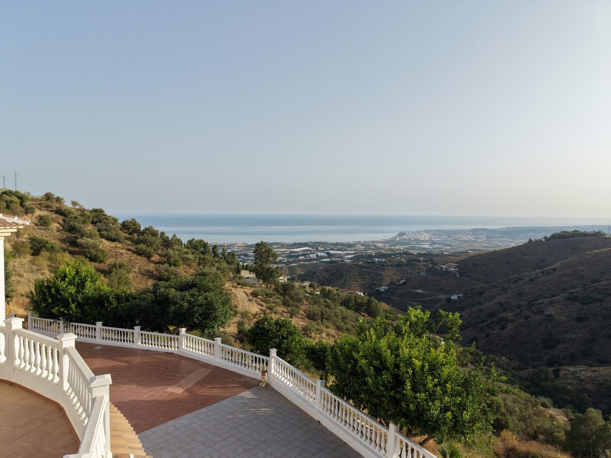Hillside terrace with ocean view and distant cityscape