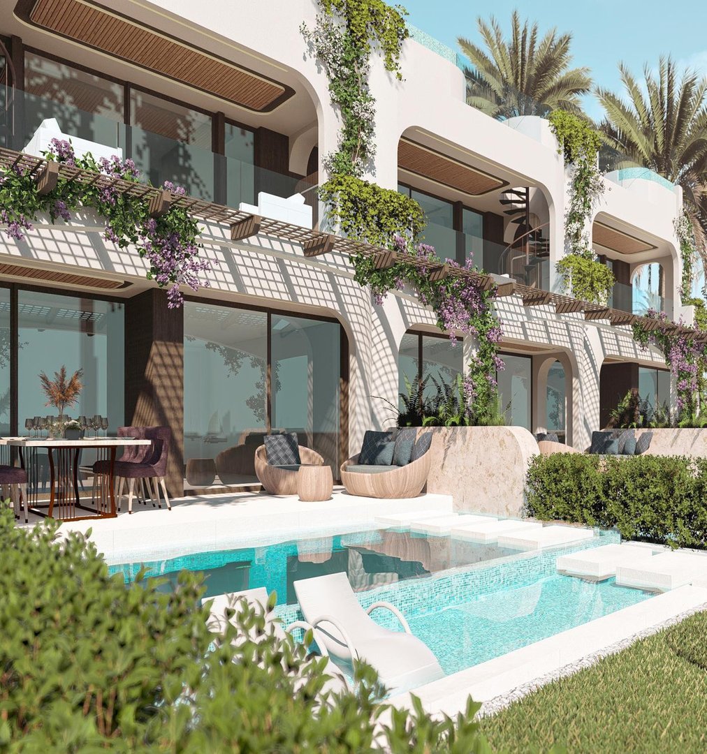 Modern villa with a private pool, outdoor seating area, and lush greenery, featuring balconies with ocean views.