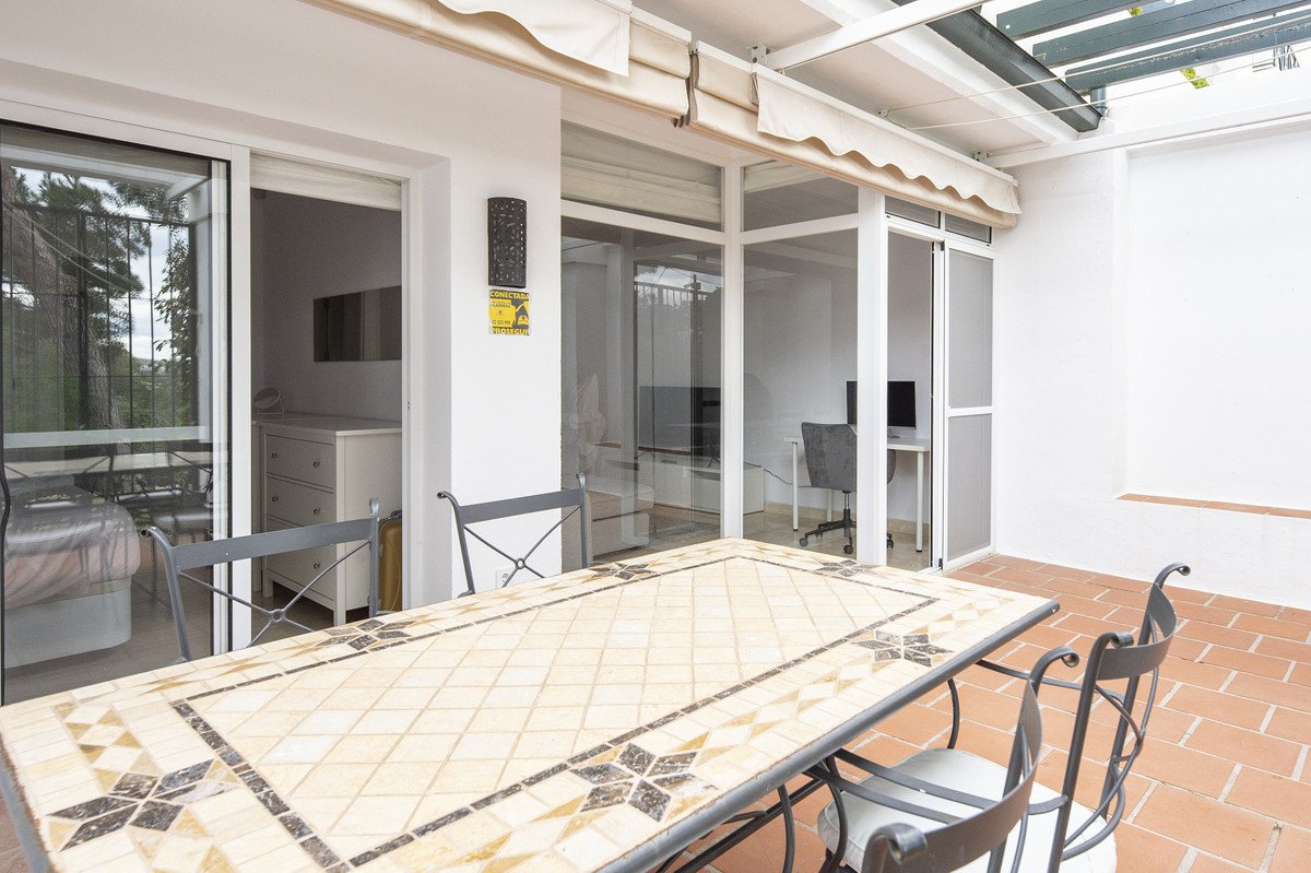 Patio with tiled table and chairs, sliding glass doors to interior