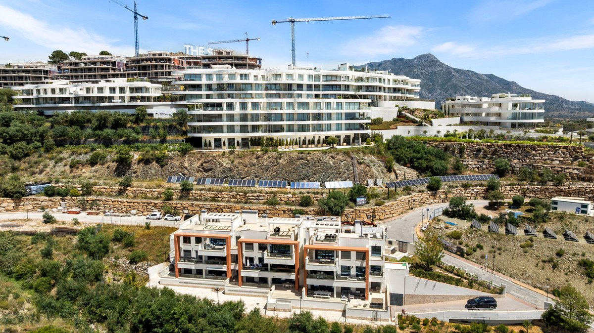 Modern apartment complex with multiple buildings and mountain view
