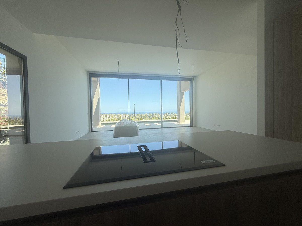 Modern living room with large windows overlooking the sea