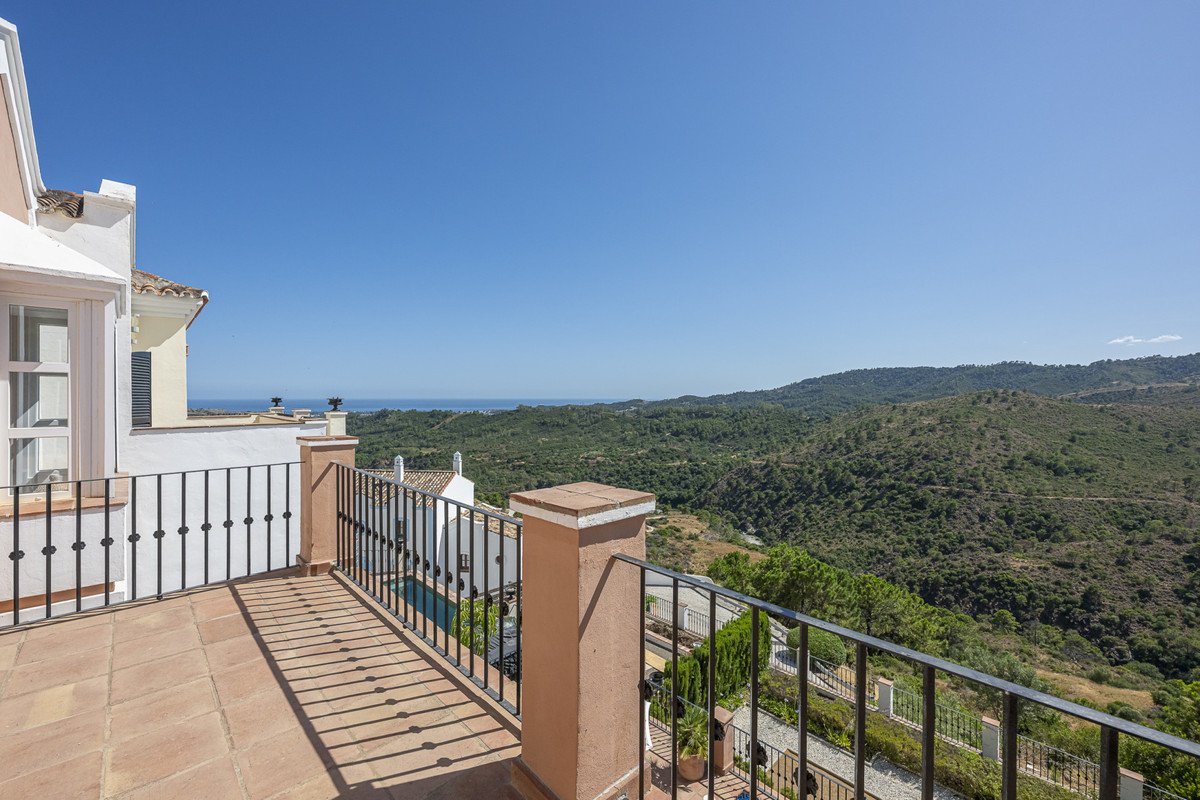 Balcony with sea view and rolling hills in the background