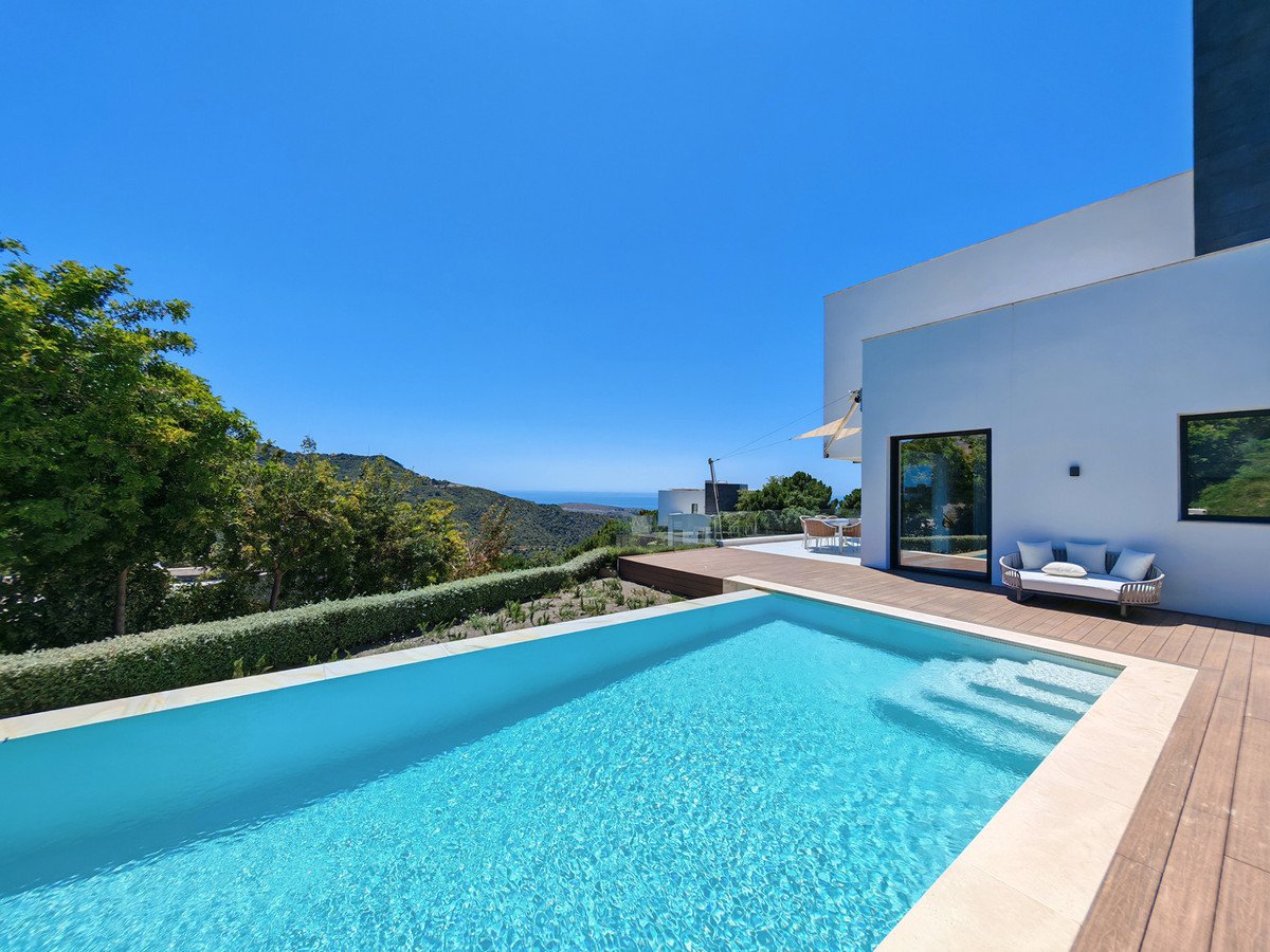 Modern swimming pool with sea view and outdoor seating area
