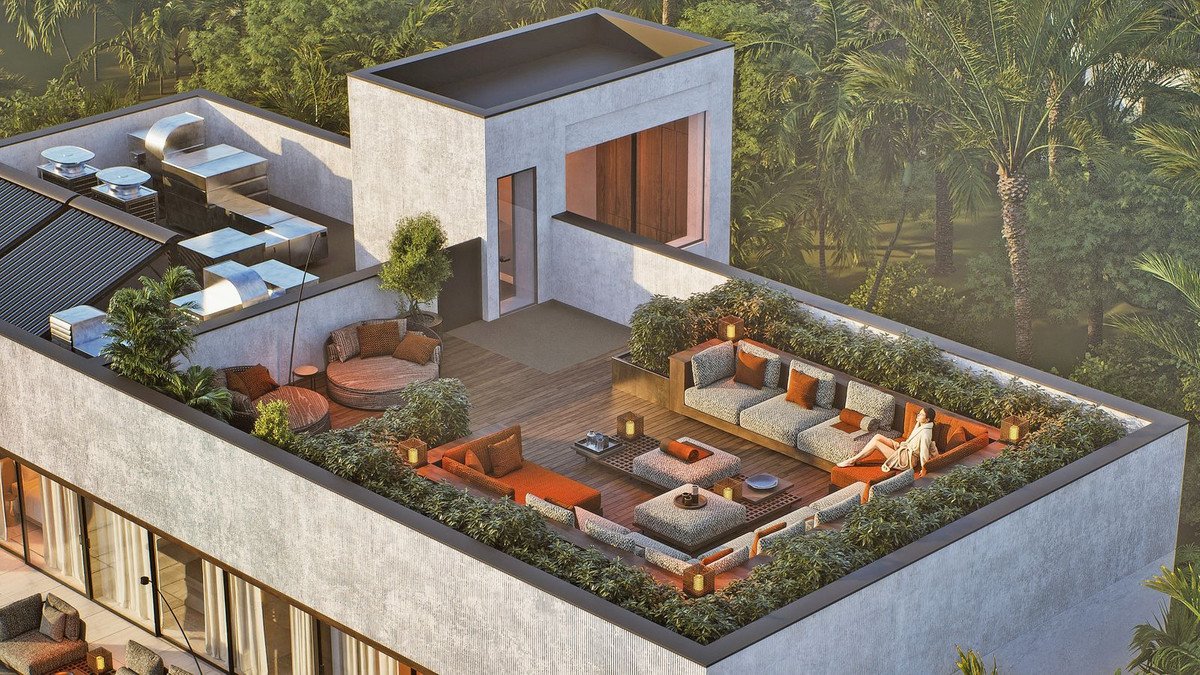 Modern rooftop terrace with lounge seating, greenery, and a view of palm trees.