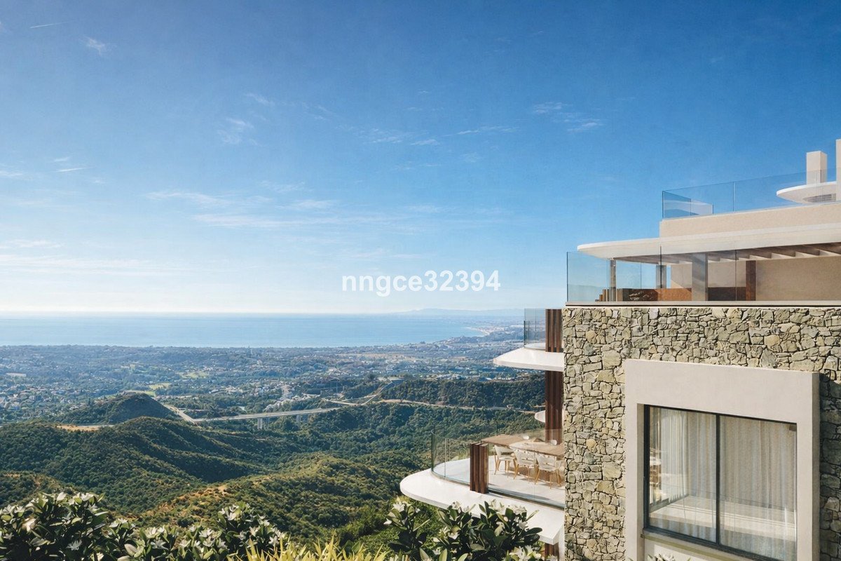 Modern villa terrace with stunning ocean and landscape views under a clear blue sky.