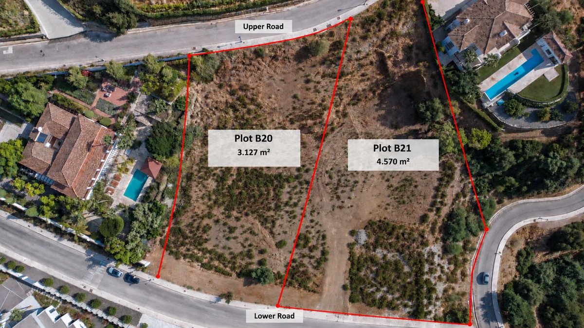 Aerial view of two adjacent land plots, Plot B20 and Plot B21, bordered by roads and near a villa with a swimming pool.