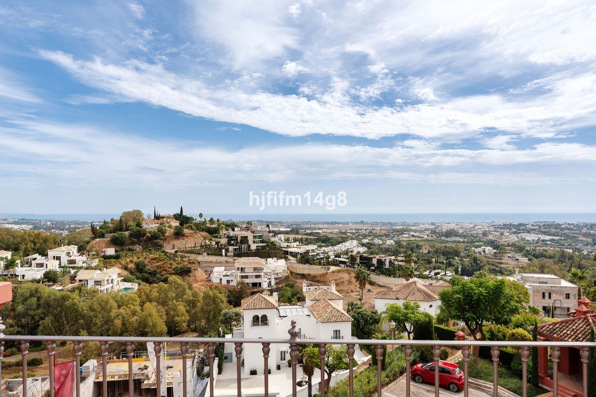 Balcony with panoramic sea view over white villas and hills