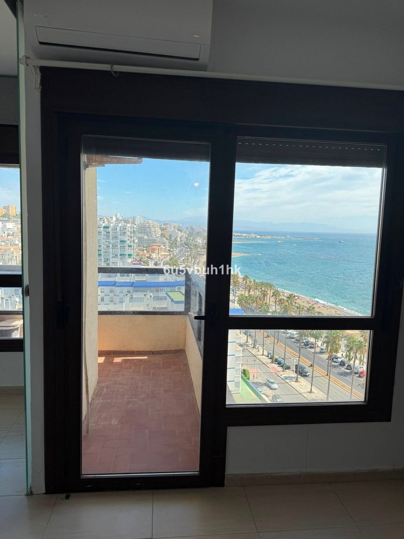 Apartment with balcony overlooking sea and cityscape