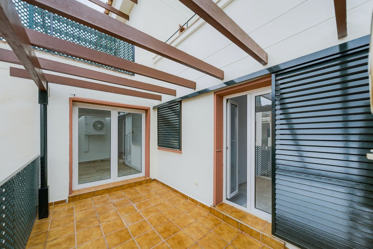 Terrace with tiled floor, sliding doors, and a slatted external shutter. outdoor shutter. outdoor covering. AC unit visible through one door.