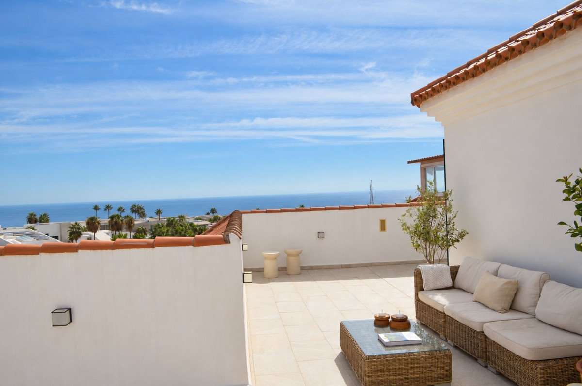 Rooftop terrace with outdoor seating and ocean view