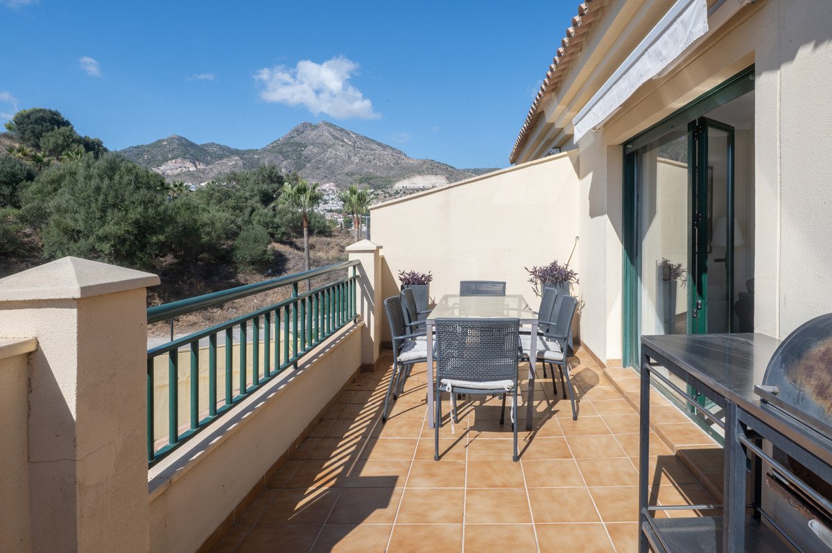 Balcony with outdoor dining set and mountain view