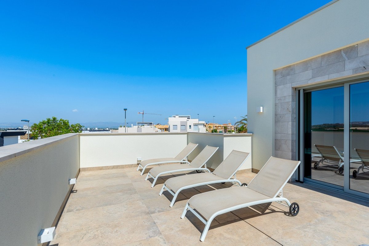 Balcony with sunbeds overlooking the sea and cityscape