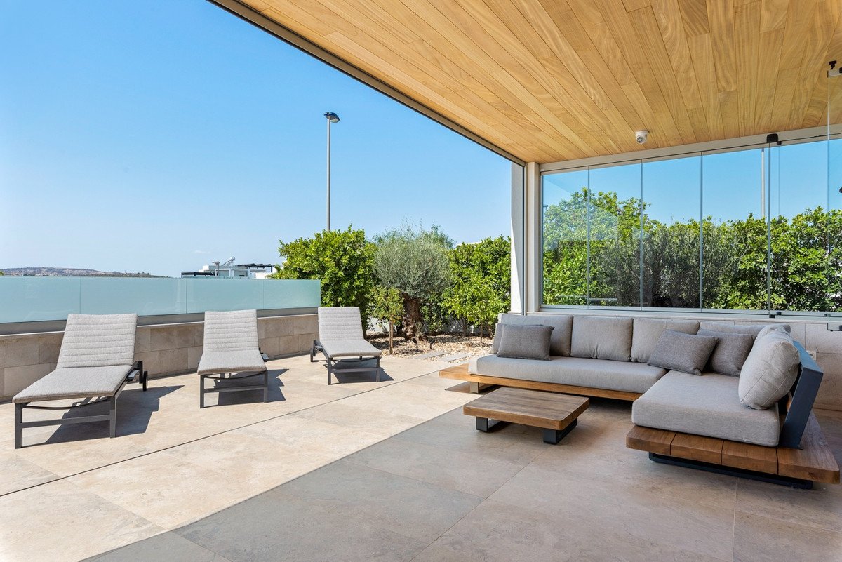 Modern outdoor lounge with seating and ocean view