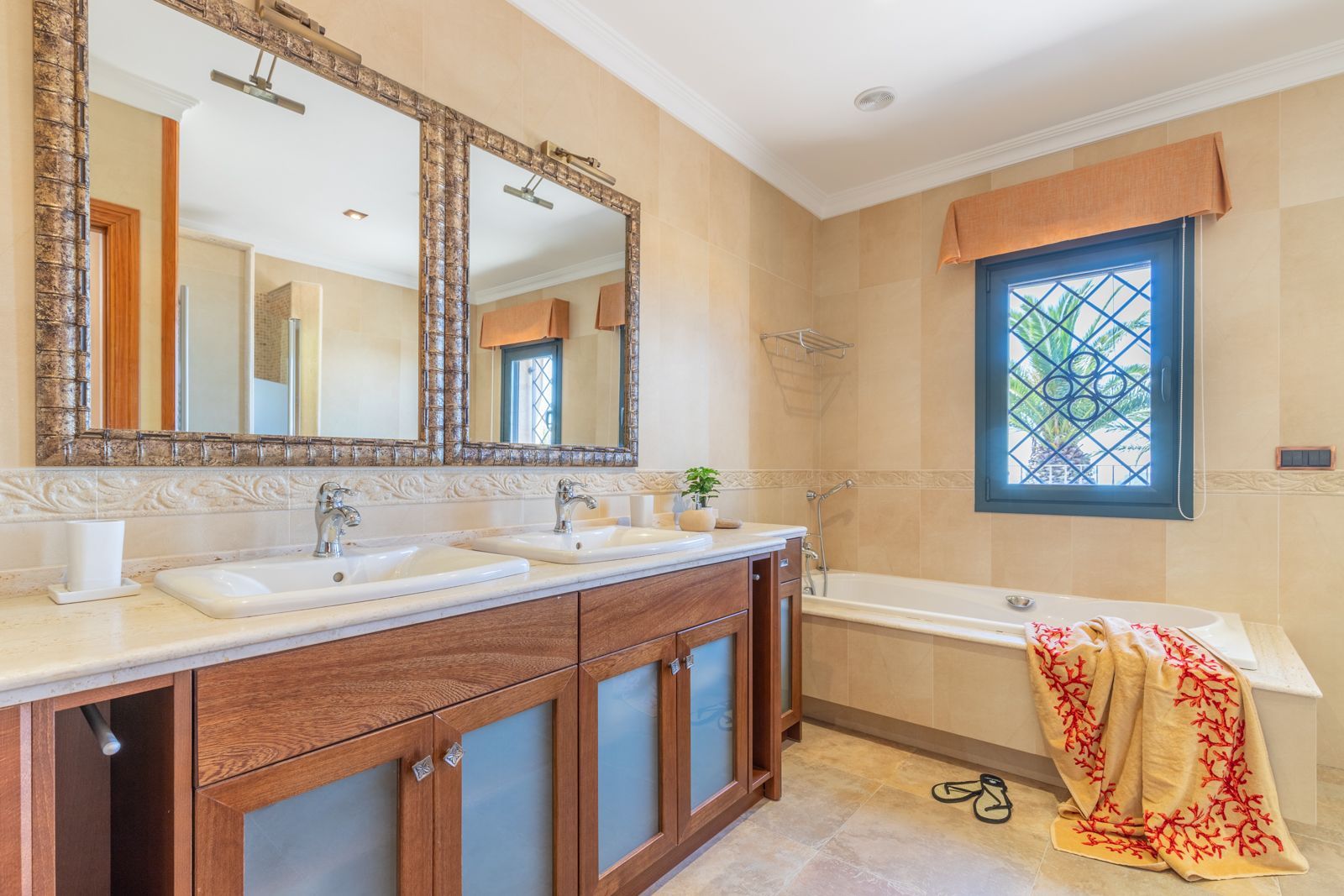 Lichte badkamer met dubbele wastafel en bad