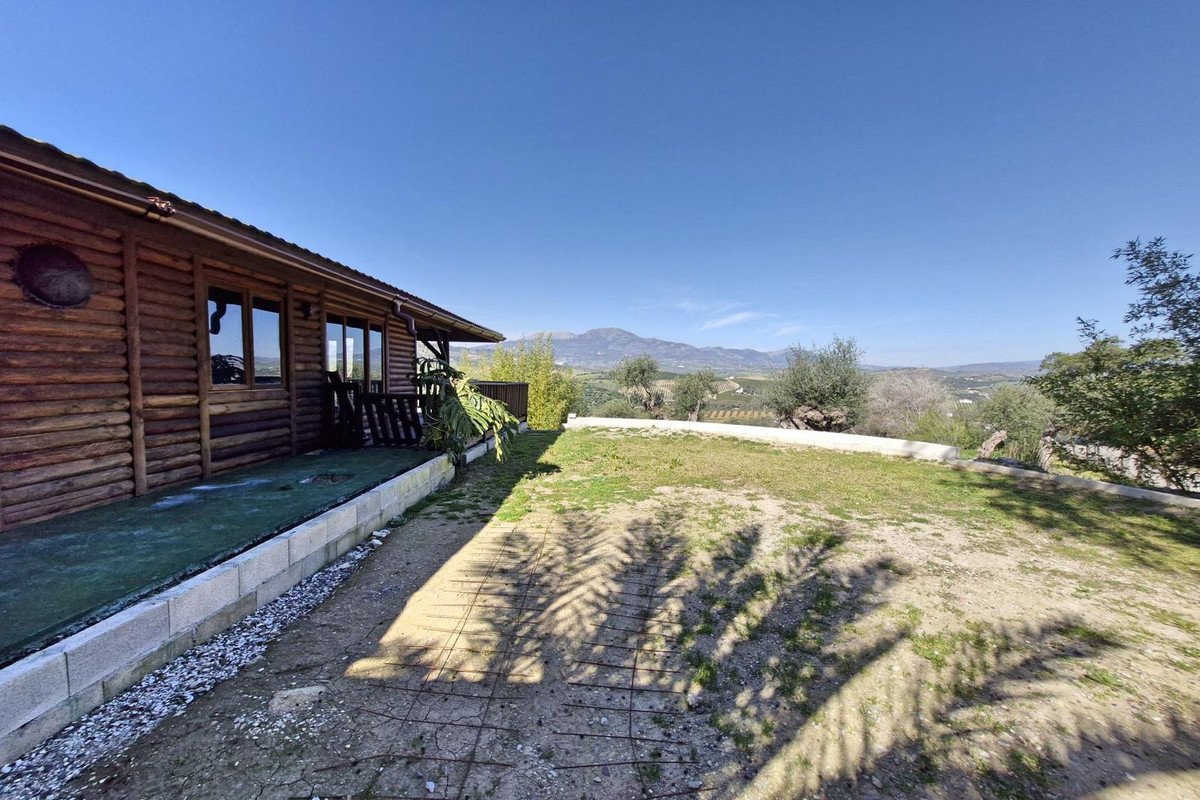 Wooden house with large windows overlooking a scenic mountain view
