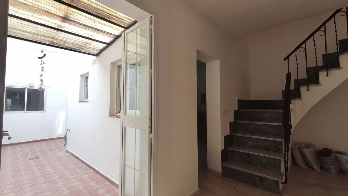 Interior living room with a staircase and large windows