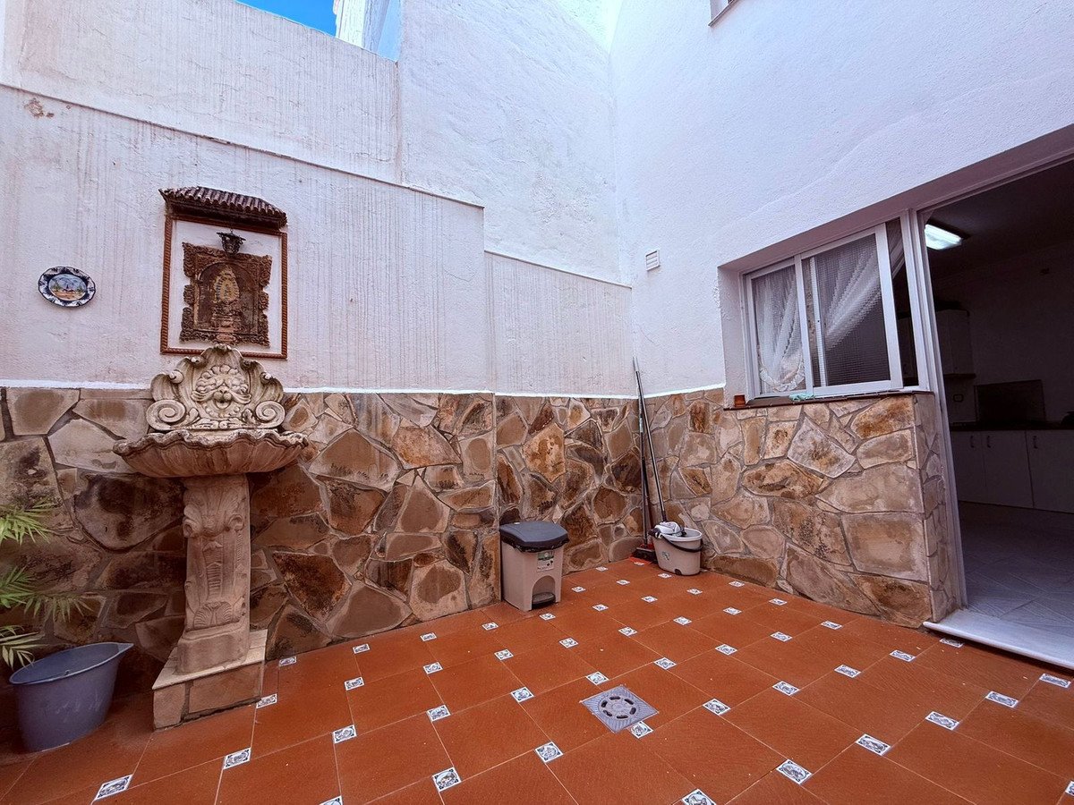 Stone-walled terrace with traditional fountain and tiled floor