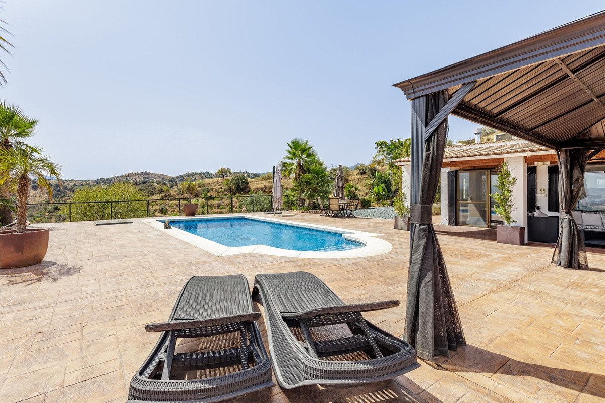 Outdoor swimming pool with lounge chairs and scenic view