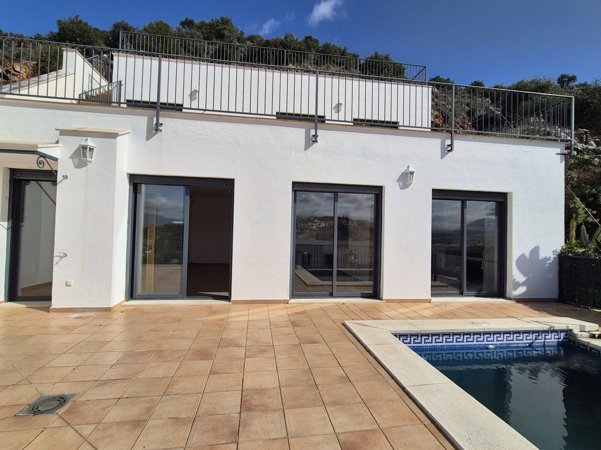 White modern house with large windows and a swimming pool
