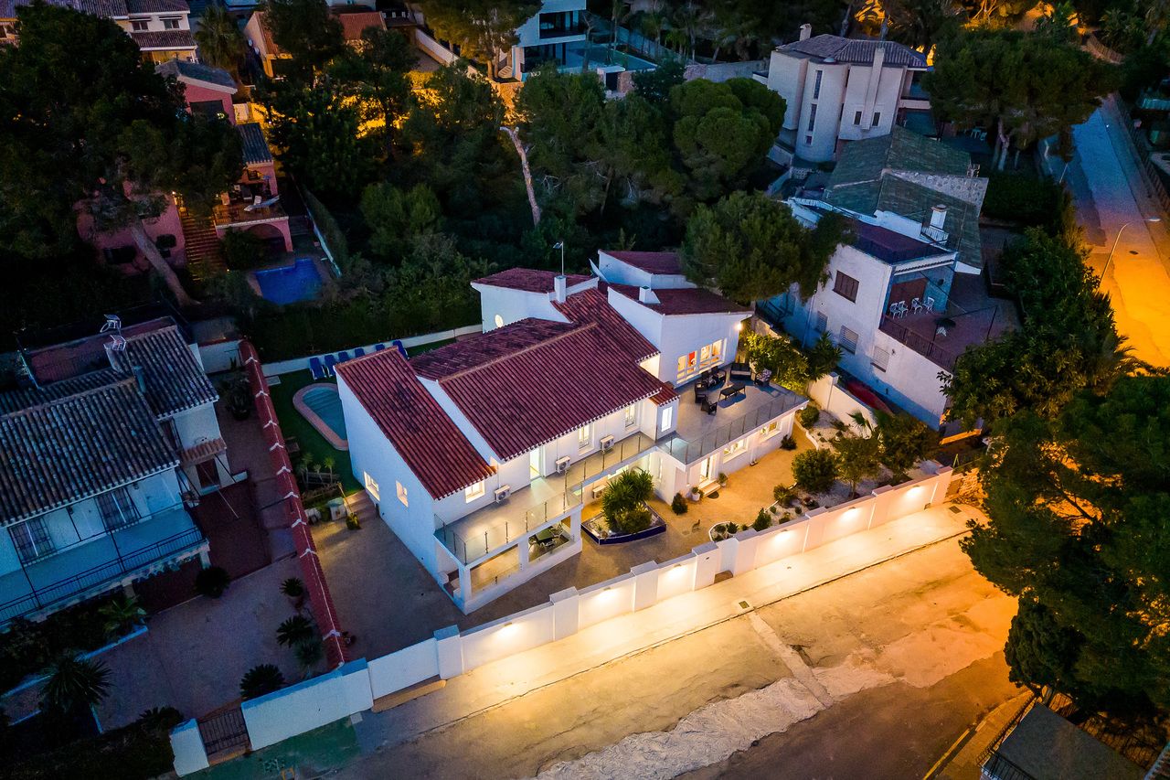 Luchtfoto van luxe villa met zwembad en tuin bij schemering