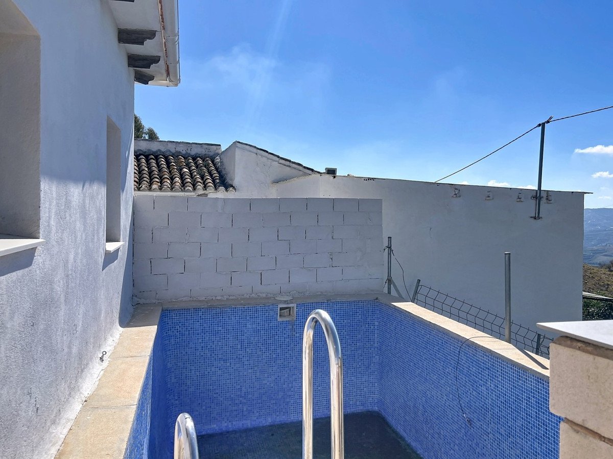 Outdoor swimming pool with blue tiles and mountain view
