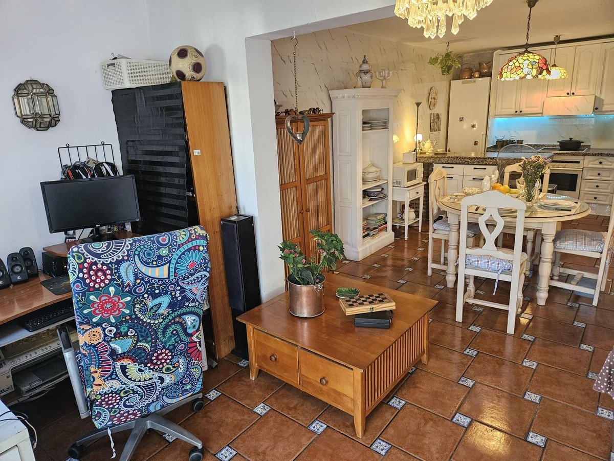 Open-plan living room with dining area and kitchen in background